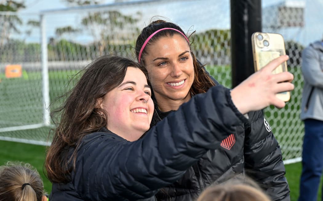 Alex Morgan has a selfie taken with a fan at Bay City Park in Auckland