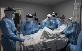 Medical staff members treat a patient suffering from Covid-19 in an intensive care unit at the United Memorial Medical Center on October 31, 2020 in Houston, Texas.