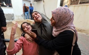 Family members mourn a baby girl killed in an Israeli strike in Rafah in the southern Gaza Strip, in the courtyard of the al-Najjar hospital on December 1, 2023, after battles resumed between Israel and the Hamas movement. (Photo by MOHAMMED ABED / AFP)