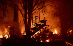 What's left of a staircase stands amidst a smoldering home as the Camp fire tears through Paradise, north of Sacramento, California.