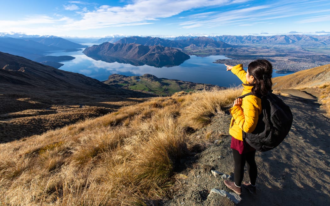 Young person hiking on Roys peak track, Wanaka, South Island, New Zealand