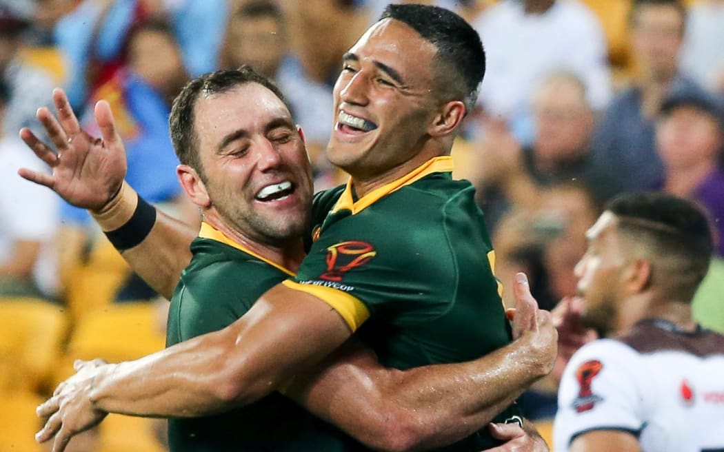 Cameron Smith celebrates with Valentine Holmes after Holmes scores his fifth try. Australia v Fiji.