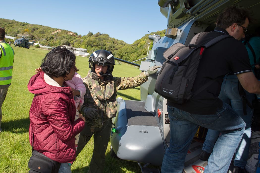 Parents and children are evacuated from Kaikoura by the New Zealand Defence Force.