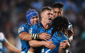 Ma'a Nonu celebrates with team mates after scoring a try for the Blues