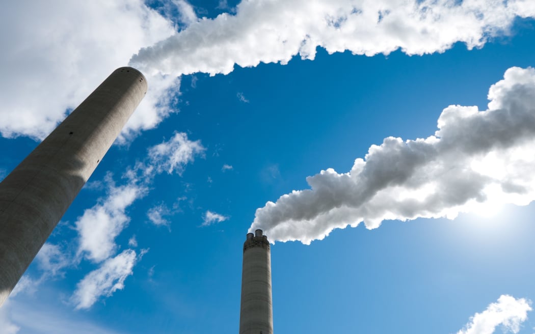 Daily News | Online News 14596413 - smoking industrial chimneys against a blue sky