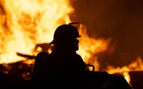 MINNEAPOLIS, MN - MAY 27: Fire fighters work to put out a fire at a factory near the Third Police Precinct on May 27, 2020 in Minneapolis, Minnesota.
