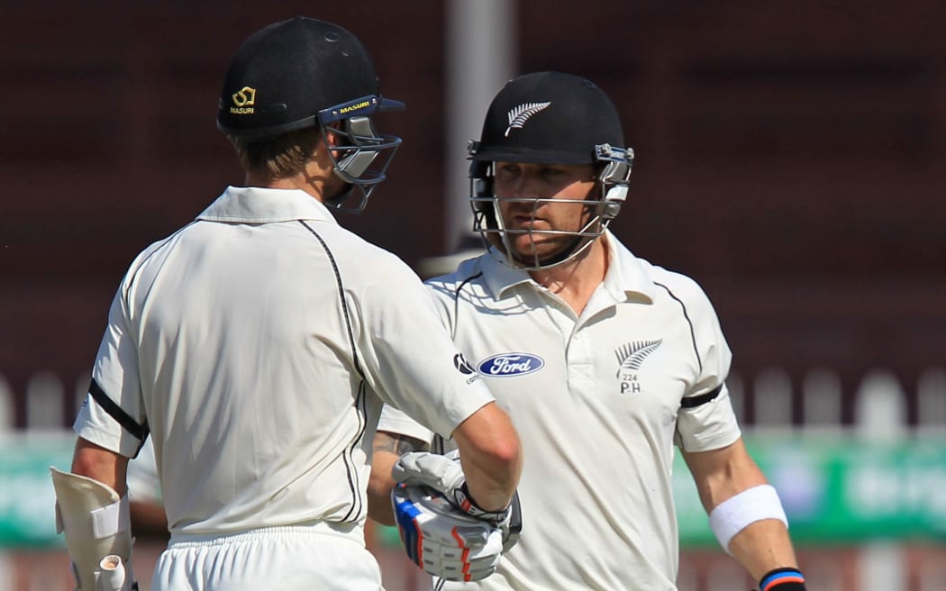 Brendon McCullum is congratulated by Kane Williamson after the skipper's dismissal for 202