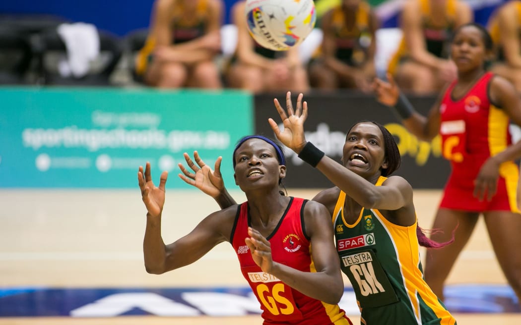 Uganda netball captain Peace Proscovia (L) in a match against South Africa