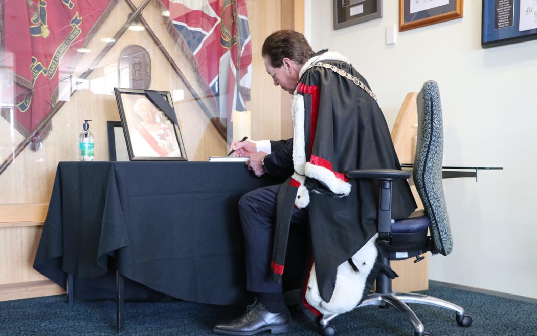 Invercargill Mayor Sir Tim Shadbolt signs a condolence book after the death of Queen Elizabeth II.