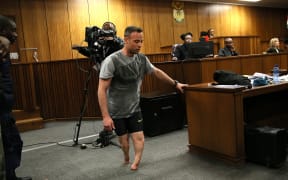 Paralympic athlete Oscar Pistorius walks in the courtroom without his prosthetic legs during his resentencing hearing for the 2013 murder of his girlfriend Reeva Steenkamp at the Pretoria High Court on June 15, 2016.