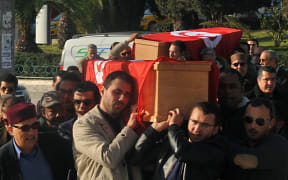 Relatives and friends carry the coffins of husband and wife Mohamed Azzabi and Senda Nakaa who were victims of the Istanbul nightclub shooting on New Year's Eve, during their funeral at a cemetary in La Marsa, near the capital Tunis, on January 3, 2017.