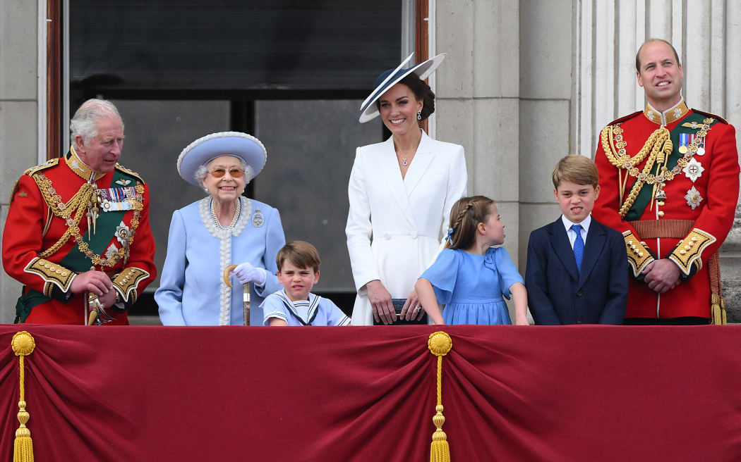Queen Elizabeth II  stands with, from left, Britain's Prince Charles, Prince Louis of Cambridge, Catherine, Duchess of Cambridge, Princess Charlotte of Cambridge, Prince George of Cambridge, Prince William, Duke of Cambridge, to watch a special flypast from Buckingham Palace balcony as part of Queen Elizabeth II's platinum jubilee celebrations, in London on 2 June 2022.