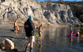 A winter dip: Swimmers prepare to plunge into freezing Otago lake