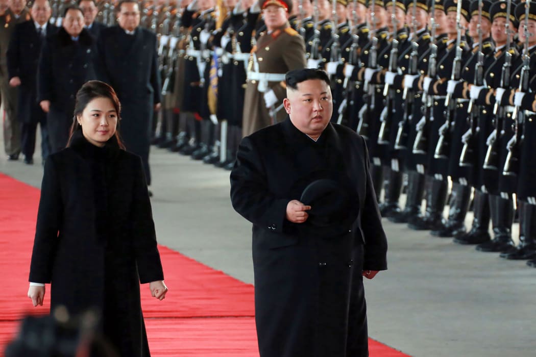 North Korean leader Kim Jong-un (right) and his wife Ri Sol-Ju leaving Pyongyang Station to visit China.