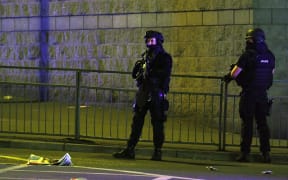 Police stand guard outside Manchester Arena after a blast