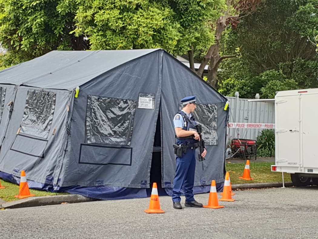 An armed guard outside Stanbury Avenue house in Somerfield, Christchurch