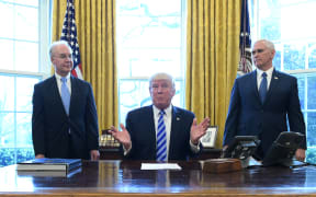US President Donald Trump, with Vice President Mike Pence and Health and Human Services Secretary Tom Price, speaks from the Oval Office of the White House in Washington DC after his healthcare bill was pulled.