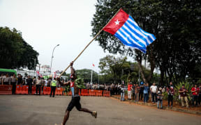 A Papuan student waves the West Papua flag, the Morning Star during a rally in Jakarta, Indonesia, on 28 August, 2019.