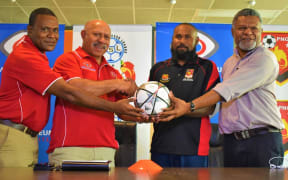 PNGFA President John Kapi Natto (2L) and   Tonga Esira (2R) at the launch of the National Soccer League's New Guinea Islands Conference.