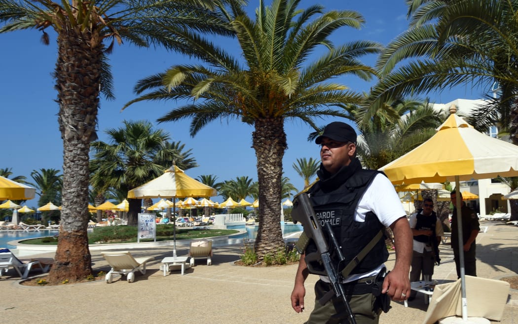 A Tunisian security member stands next to a swimming pool at the resort town of Sousse following the attack.