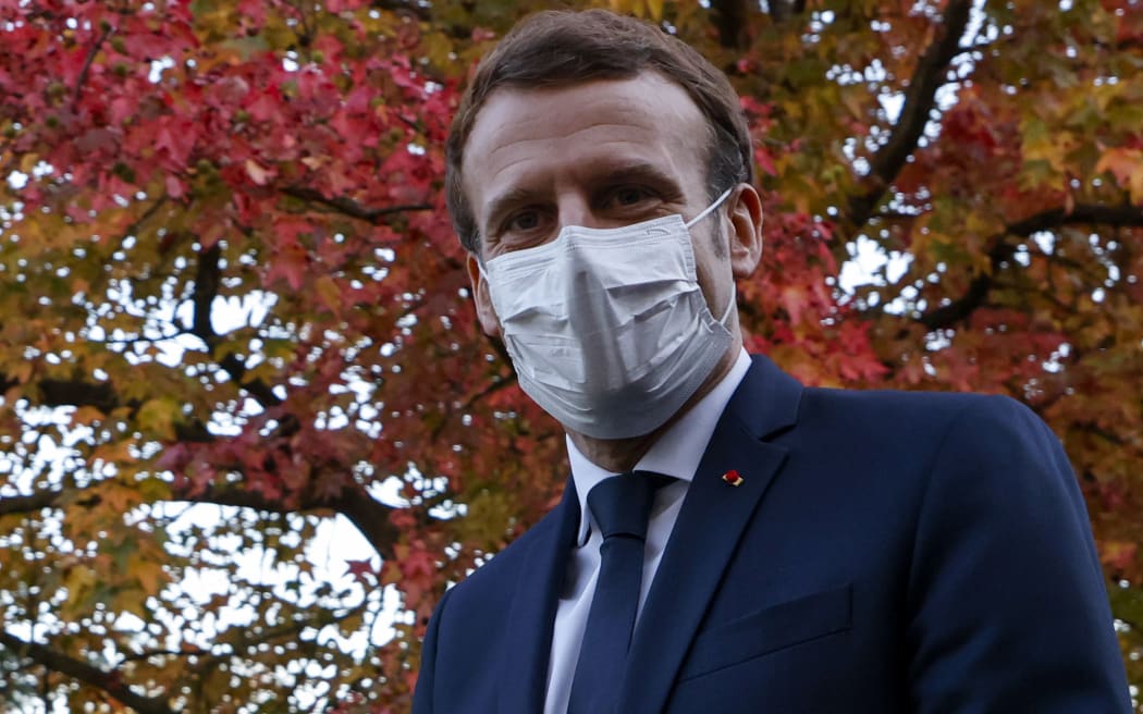 French President Emmanuel Macron looks on as he speaks to the press after chairing a meeting with the medical staff of the Rene Dubos hospital center, in Pontoise, in the Val d'Oise, on October 23, 2020,