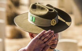 Australian Army Recruit Instructor (RI) Chris Purdie salutes a grave during a ceremony at El Alamein War Cemetary marking 75 years since the pivotal WWII battle, in the Egyptian Mediterranean town of the same name, about 100km west of Alexandria.