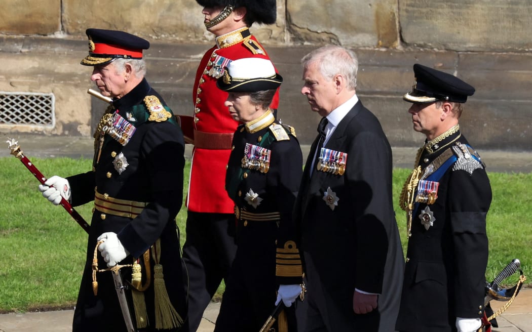 King Charles III, flanked by Princess Anne, and princes Andrew and Edward, walk behind the procession of Queen Elizabeth II's coffin, from the Palace of Holyroodhouse to St Giles Cathedral, on 12 September 2022.