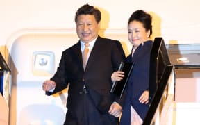 Xi Jinping and his wife Peng Liyuan as they arrived at Auckland International Airport.