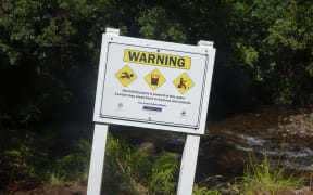 Signs warning people to stay out of the river went up in December