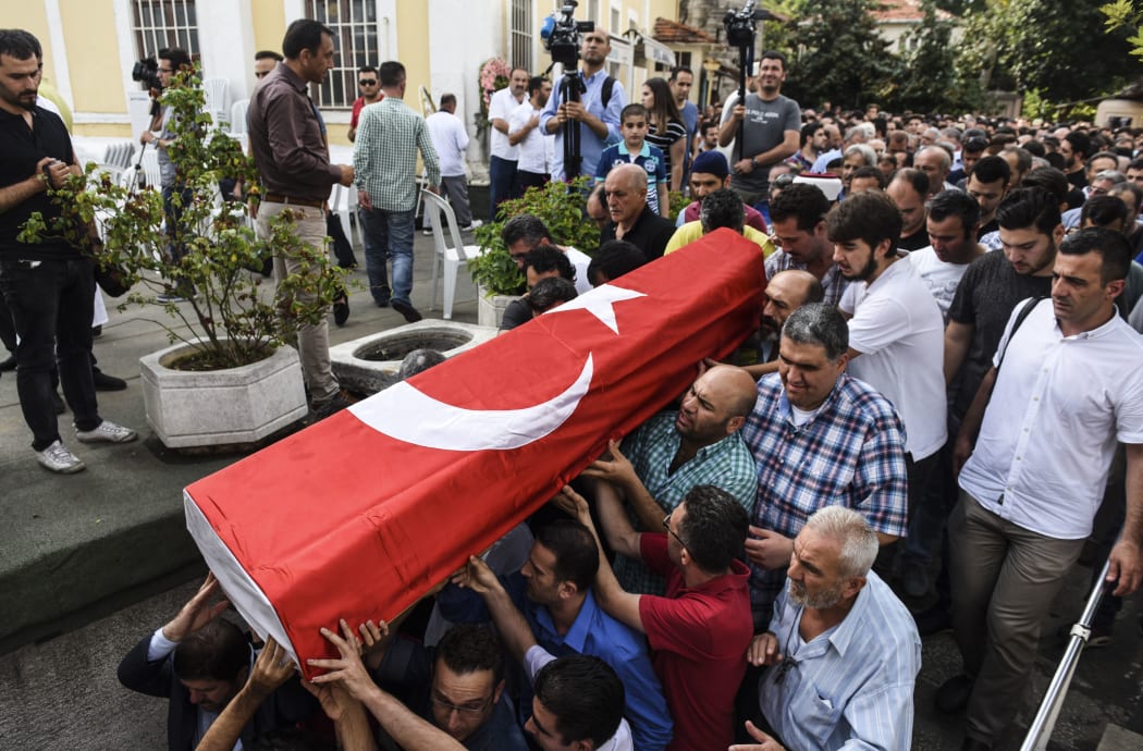 People carry the coffin of Huseyin Tunc, covered with the Turkish national flag in Istanbul on June 30, 2016 two days after the triple suicide bombing and gun attack occurred at Istanbul's Ataturk airport.