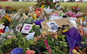 Pictures of Christchurch mosques attack victims sits above flowers at a memorial site near the Al Noor mosque.