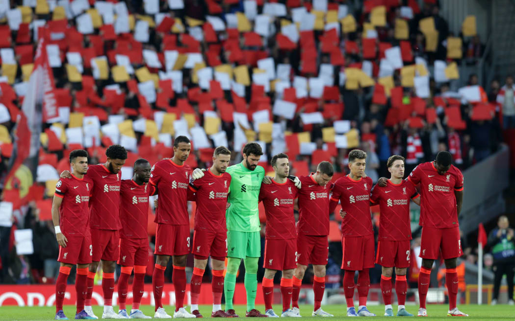 Liverpool players line up in front of the Kop for a minute’s silence in memory of the 97 victims of the Hillsborough disaster, 2022.