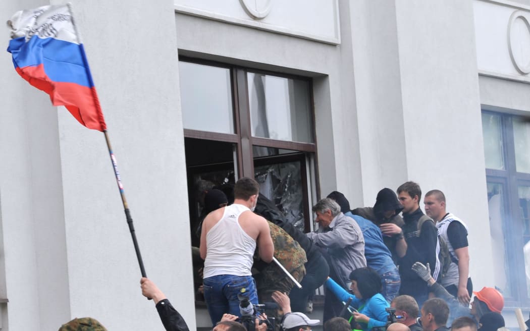 Pro-Russian activists break into the regional administration building in Luhansk.