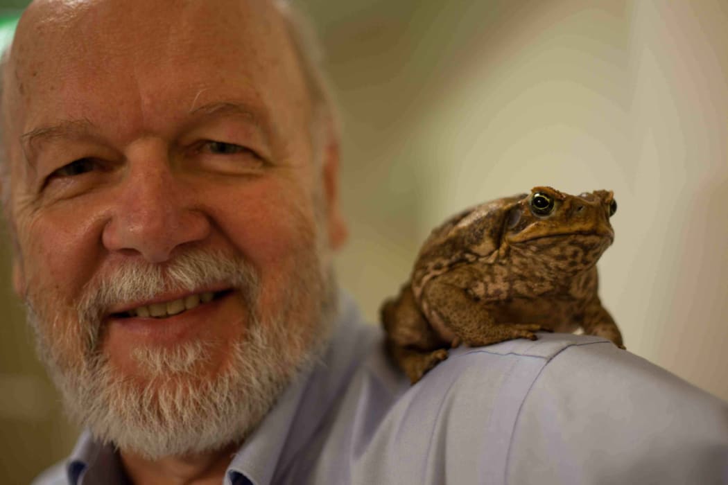 Professor Rick Shine with a cane toad on his shoulder