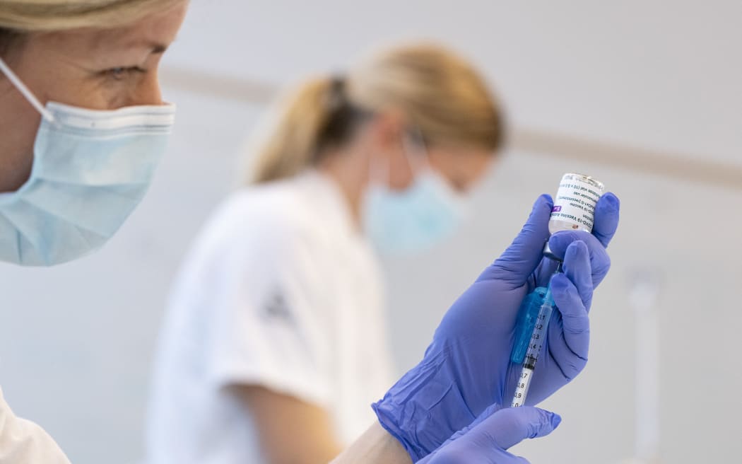 A nurse wearing gloves holding a syringe which is being filled with Covid-19 vaccine made by AstraZeneca in Malmo, Sweden
Photo: Johan Nilsson / TT / Code 50090