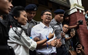 Reuters journalist Wa Lone speaks to journalists outside court.
