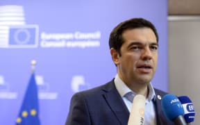 Greek Prime Minister Alexis Tsipras talks to the media at the end of an Eurozone Summit over the Greek debt crisis in Brussels on July 13, 2015.