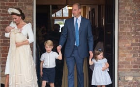 Britain's Princess Charlotte of Cambridge and Britain's Prince George of Cambridge hold hands with their father, Britain's Prince William, Duke of Cambridge, as Britain's Prince Louis of Cambridge is carried by his mother, Britain's Catherine, Duchess of Cambridge.