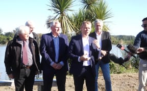 Prime Minister Chris Hipkins makes the Government co-funded package announcement on the bank of the Buller River at Westport on Friday morning, with acting West Coast Regional Council chairman Brett Cummings, left, Buller Mayor Jamie Cleine and West Coast Tasman MP Damien O'Connor.