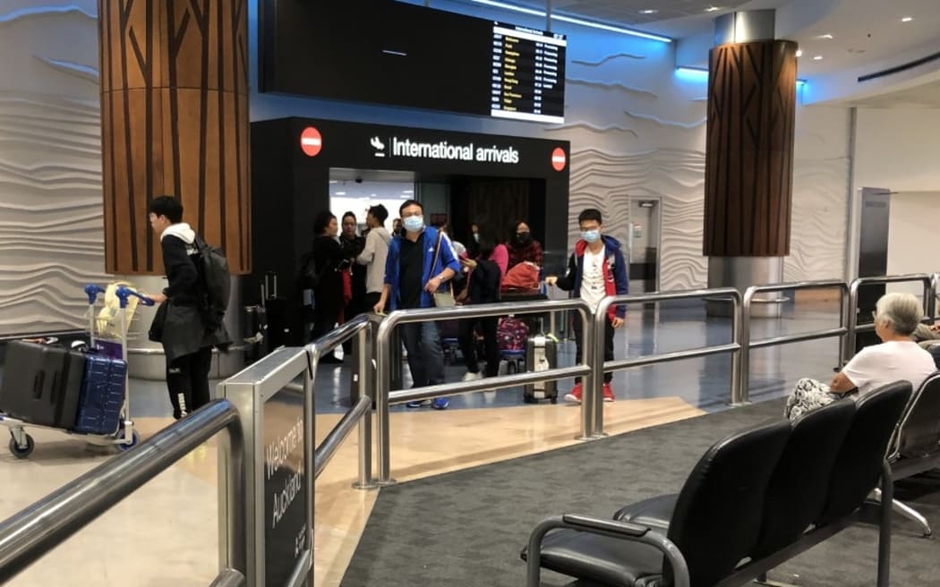 Passengers arriving at Auckland Airport in January 2020 when public health staff began giving out coronavirus information.