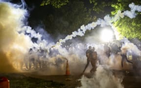 Tear gas rises as protesters face off with police during a demonstration outside the White House on 31 May over the death of George Floyd at the hands of Minneapolis Police.