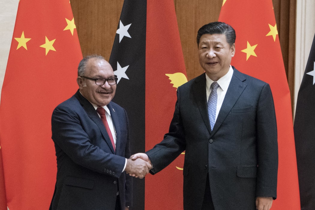 Papua New Guinea's Prime Minister Peter O'Neill (L) shakes hands with China's President Xi Jinping in June.