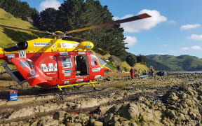 The Westpac rescue helicopter at the scene of the crash on Monday.