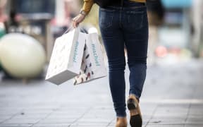 A person carrying shopping nags in Auckland on June 19, 2020.