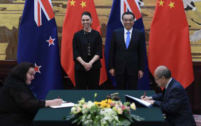 New Zealand Prime Minister Jacinda Ardern and Chinese Premier Li Keqiang during a signing ceremony in Beijing.