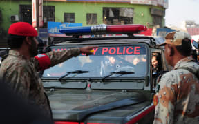 Pakistani security officials inspect a military police jeep following an attack by gunmen in Karachi on 1 December 2015.