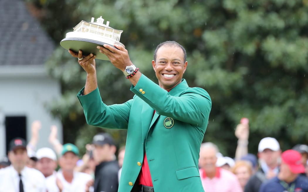 Tiger Woods celebrates with the trophy and Green Jacket during the award ceremony of the 2019 Masters.