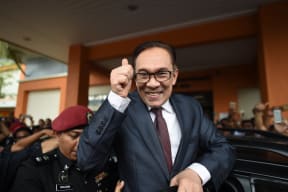 Jailed former opposition leader and current Federal opposition leader Anwar Ibrahim greets supporters after his released from the Cheras Hospital Rehabilitation in Kuala Lumpur on May 16, 2018.