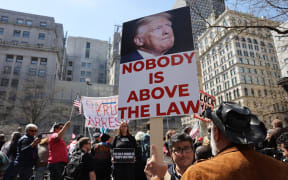 People protesting against former President Donald Trump gather outside of the Manhattan Criminal Court before his arraignment on 4 April, 2023 in New York City.