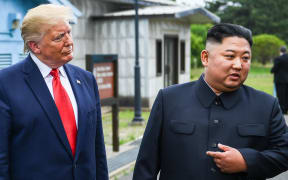 North Korea's leader Kim Jong Un speaks as he stands with US President Donald Trump south of the Military Demarcation Line that divides North and South Korea, in the Joint Security Area (JSA) of Panmunjom in the Demilitarized zone (DMZ)